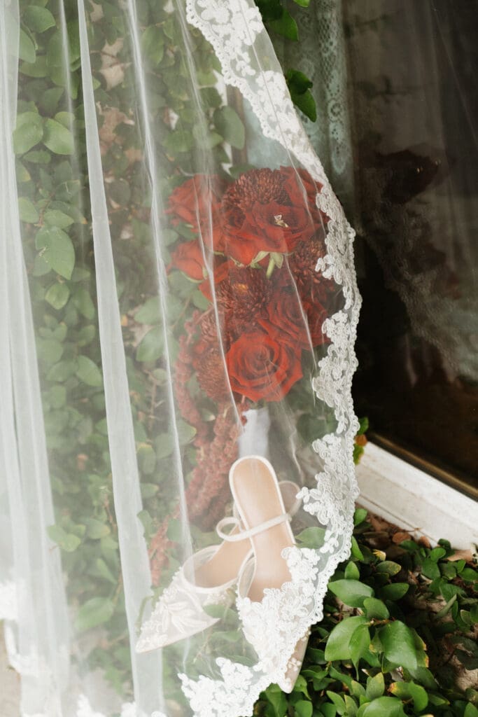 Detail photo of shoes, veil, and flowers