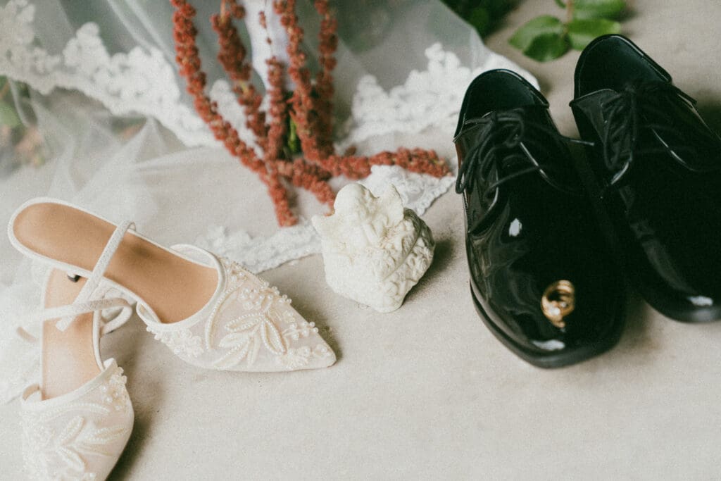 Wedding Detail photo with shoes, flowers, and angel ring box
