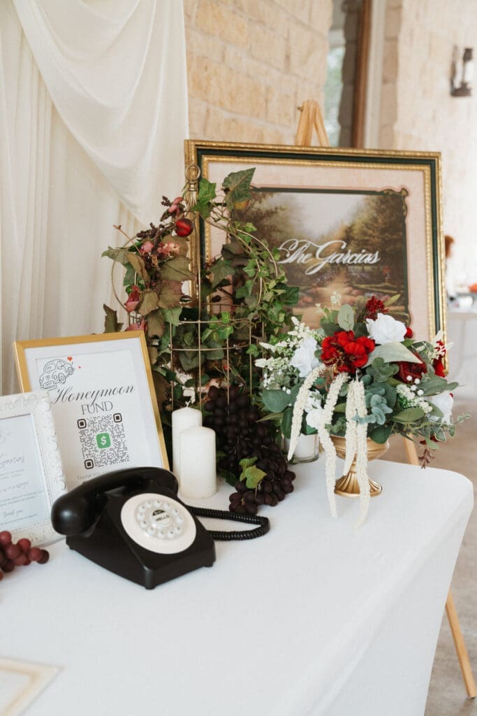 Welcome table with phone, flowers, and sign with "The Garcia's" on it