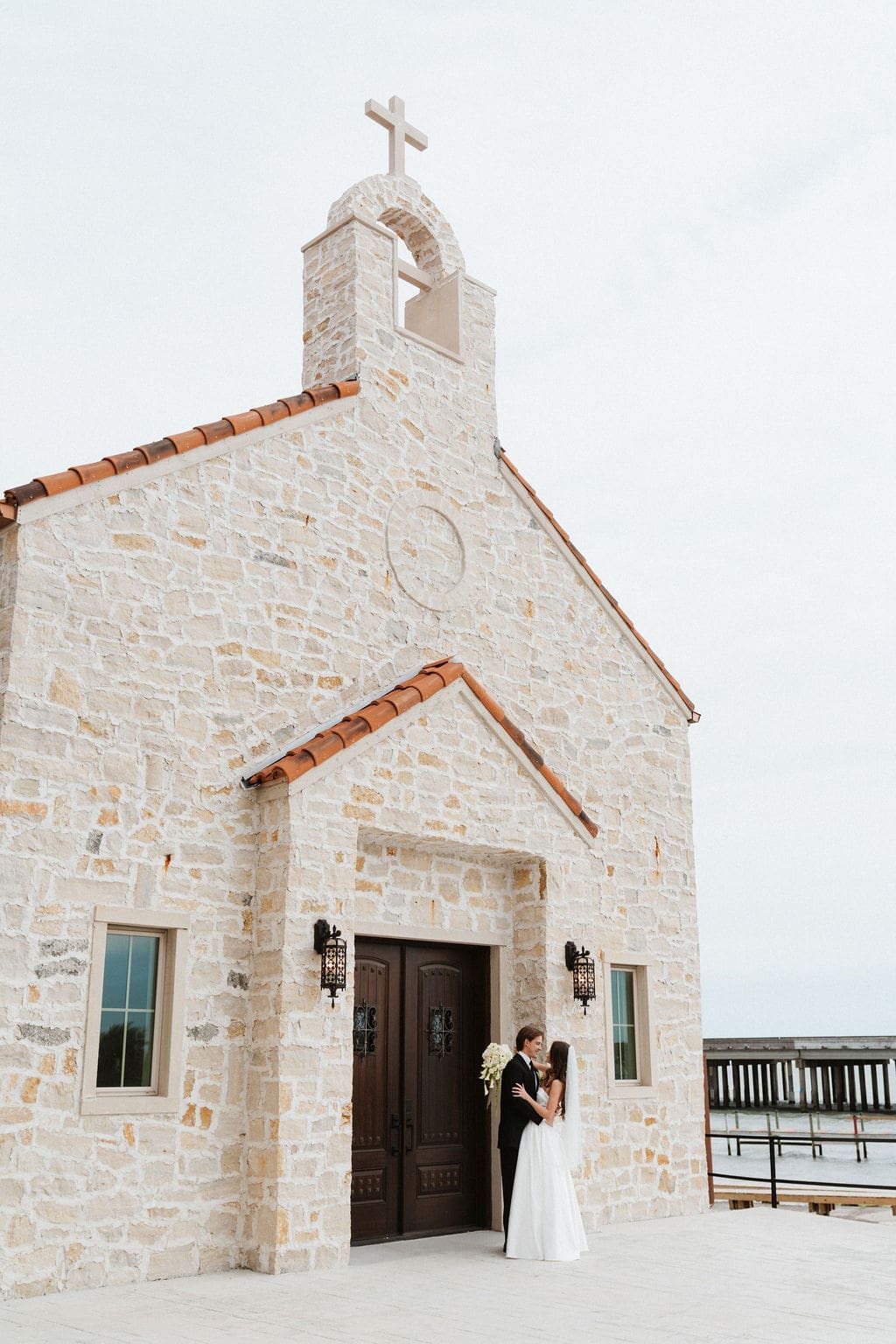 Wedding couple standing in front of a chapel